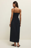 Woman wearing a black dress on a plain background