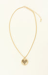 Gold necklace with a heart pendant on a white background