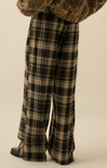 Plaid pants worn by a person on a beige background