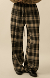 Plaid pants worn by a person on a beige background