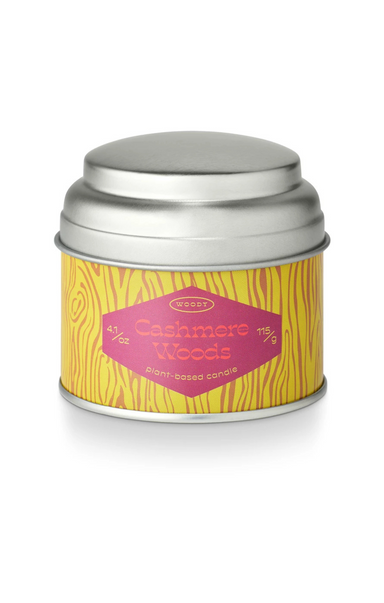 Candle tin labeled 'Cashmere Woods' with a yellow label on a white background