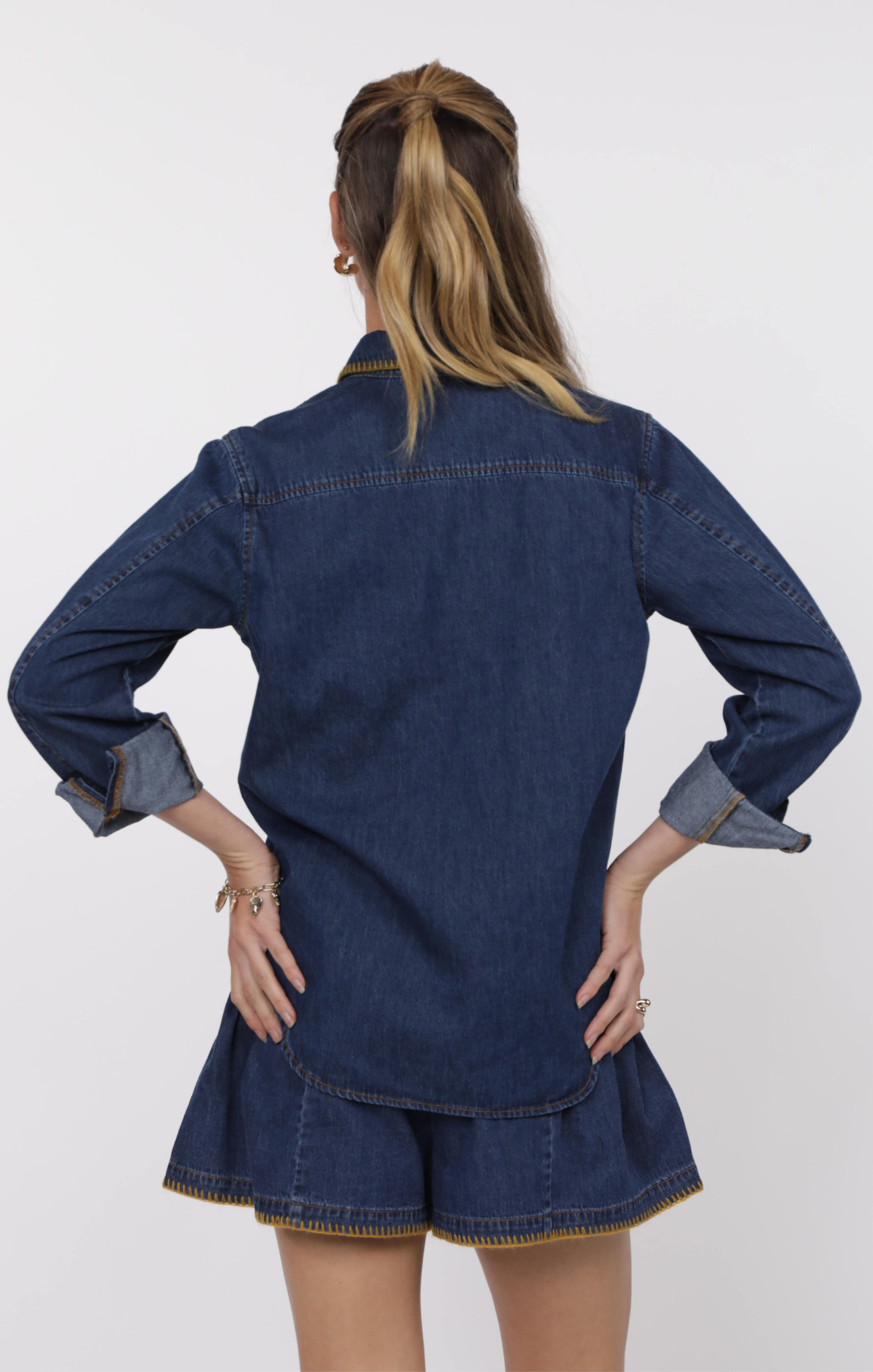 Person wearing a denim outfit with a white background