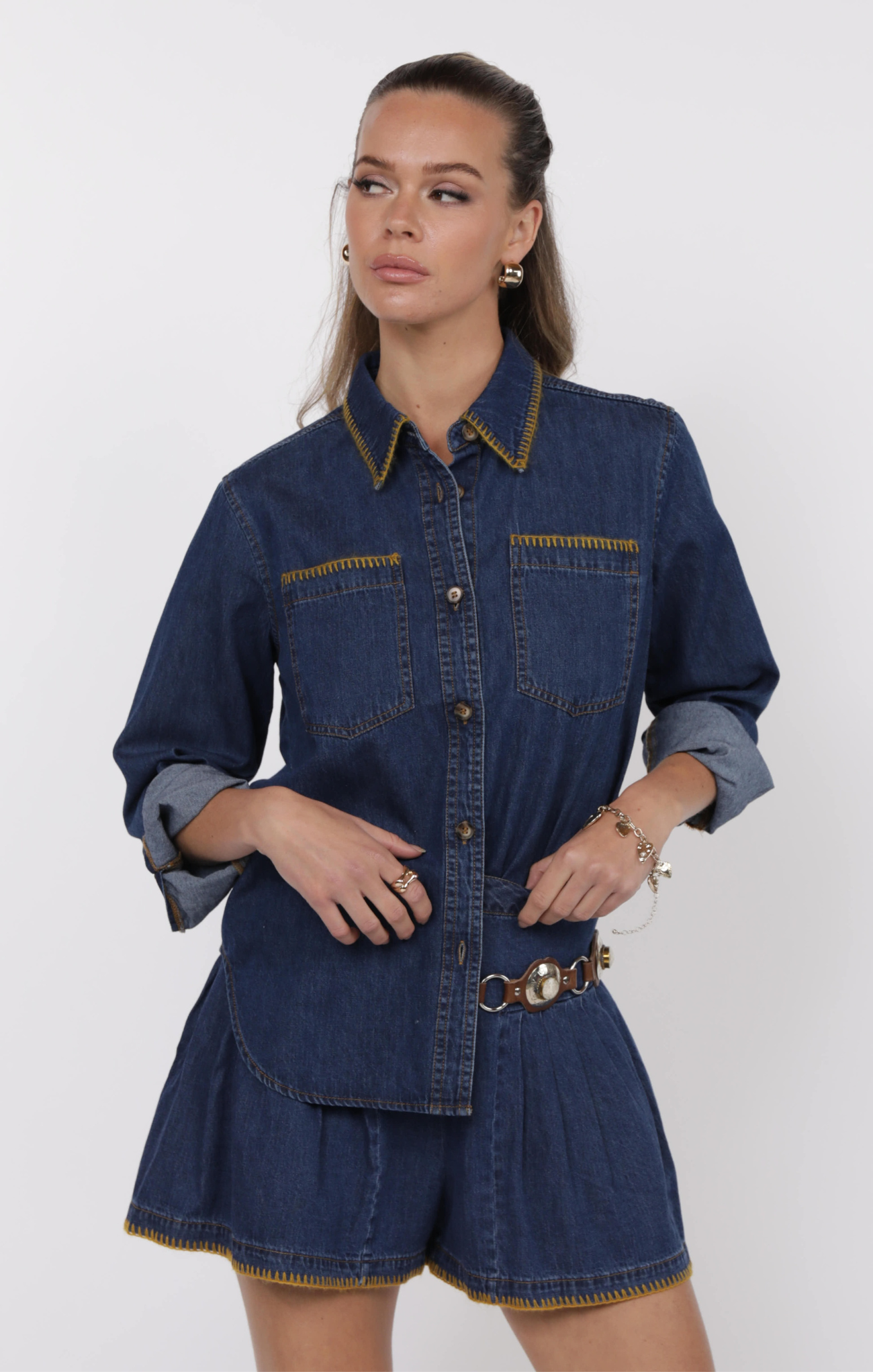 Woman wearing a denim outfit with a white background