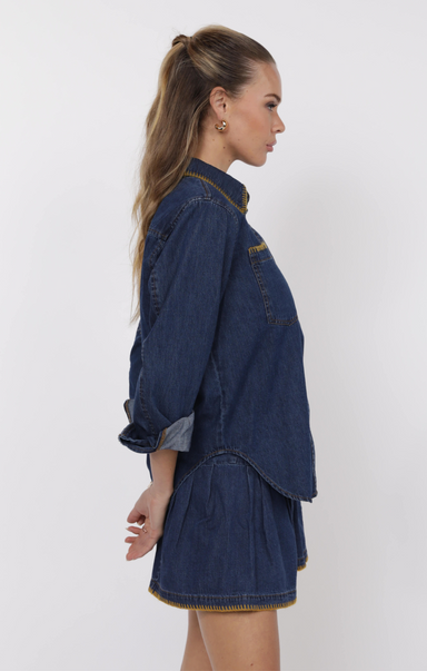 Woman wearing a denim outfit on a white background