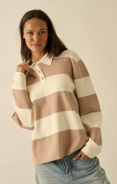 Woman wearing a striped sweater with a plain background
