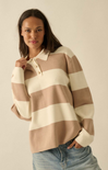 Woman wearing a striped sweater with a plain background
