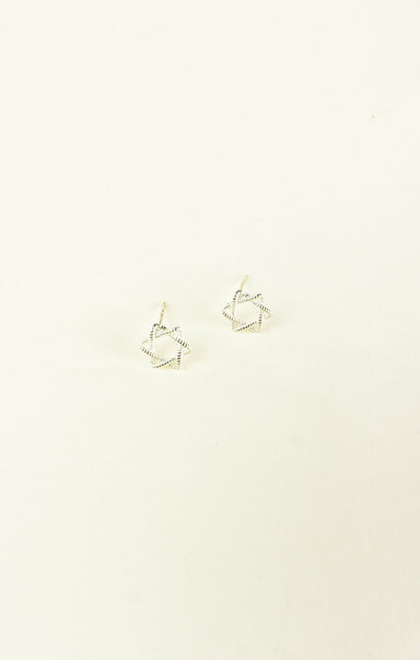 Gold geometric earrings on a beige background