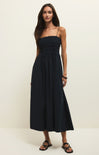 Woman wearing a black strapless dress against a white background