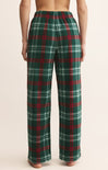 Green and red plaid pants worn by a person on a beige background