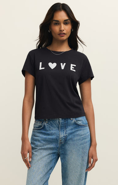 Woman wearing a black t-shirt with 'LOVE' printed on it, standing against a plain background.