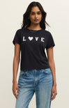 Woman wearing a black t-shirt with 'LOVE' printed on it, standing against a plain background.