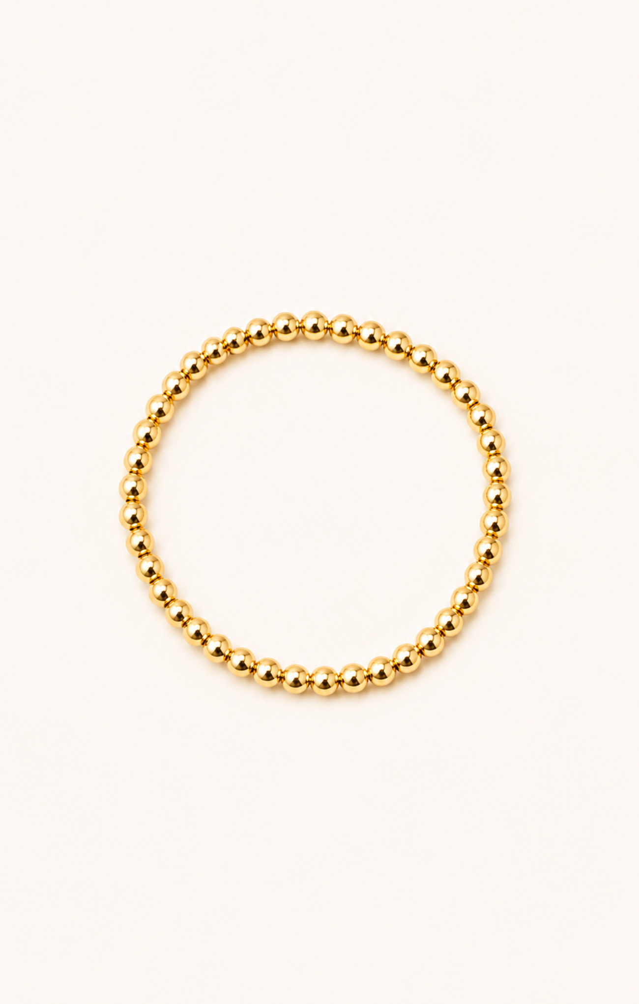 women wearing a gold bracelet at the beach