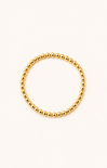 women wearing a gold bracelet at the beach