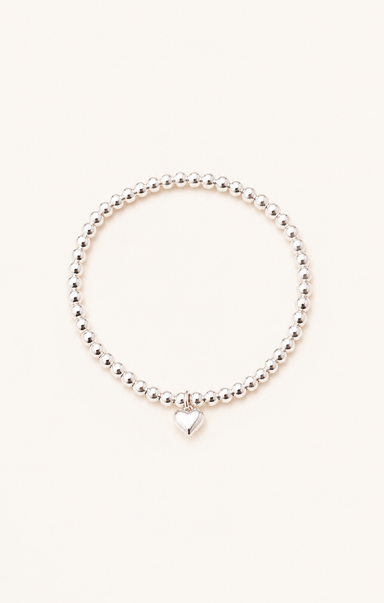 women wearing a silver bracelet on the beach