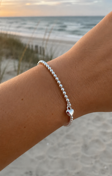 women wearing a silver bracelet on the beach