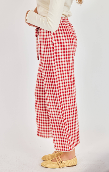 Red and white checkered pants worn by a person on a light gray background