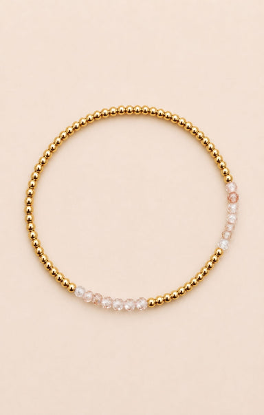 gold bracelet on neutral background