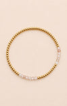 gold bracelet on neutral background