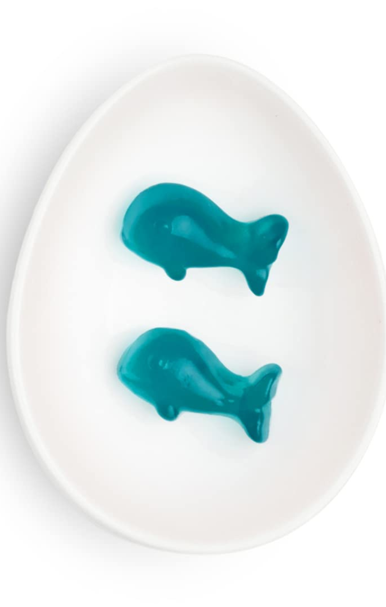 Two teal whale-shaped objects on a white plate
