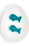 Two teal whale-shaped objects on a white plate