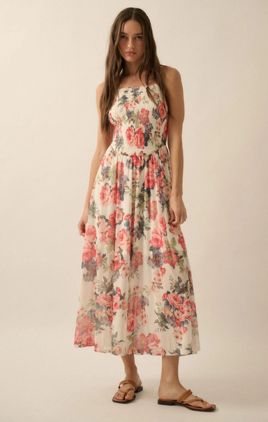 Woman wearing a floral dress against a plain background