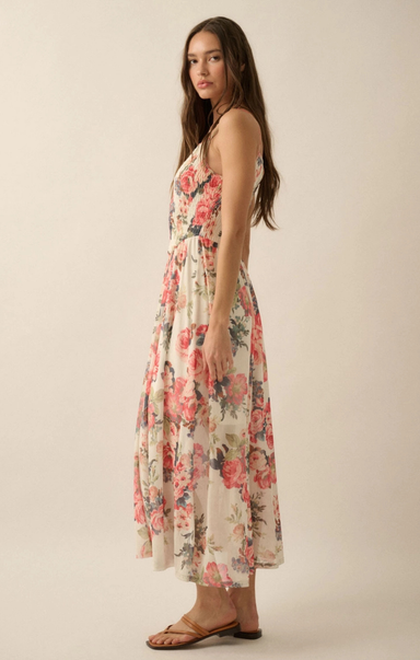 Woman wearing a floral dress against a plain background