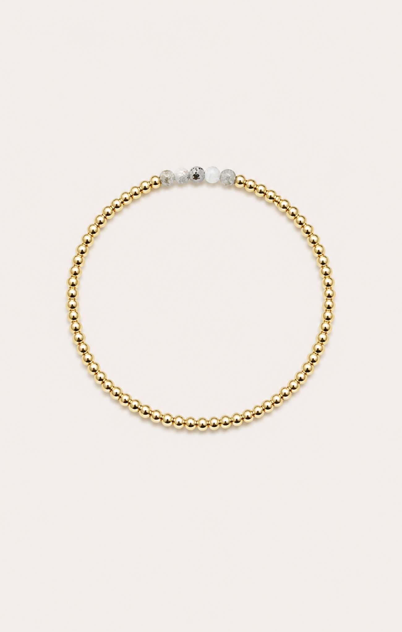 gold bracelet on neutral background

