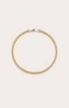 gold bracelet on neutral background

