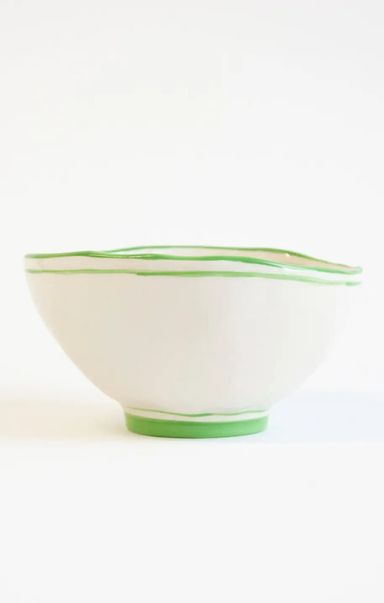 White bowl with green rim on a white background