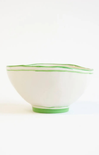 White bowl with green rim on a white background