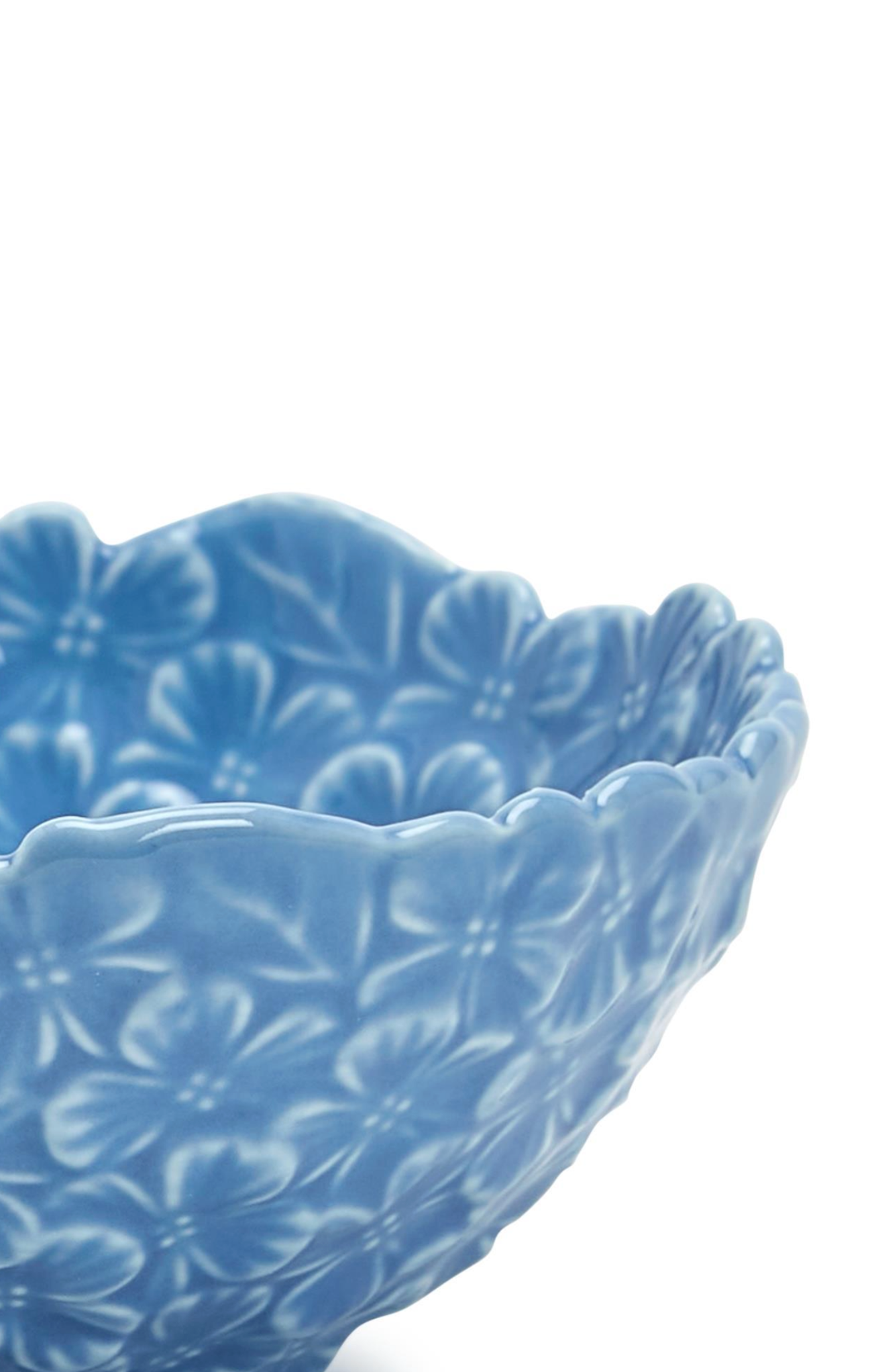 Blue ceramic bowl with floral pattern on a white background