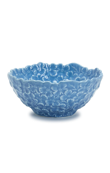 Blue ceramic bowl with floral patterns on a white background