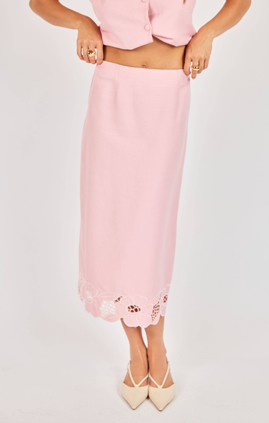 Pink skirt with floral embroidery on a white background