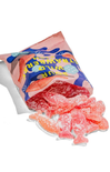 Packaged fish-shaped gummy candies with a colorful label on a white background