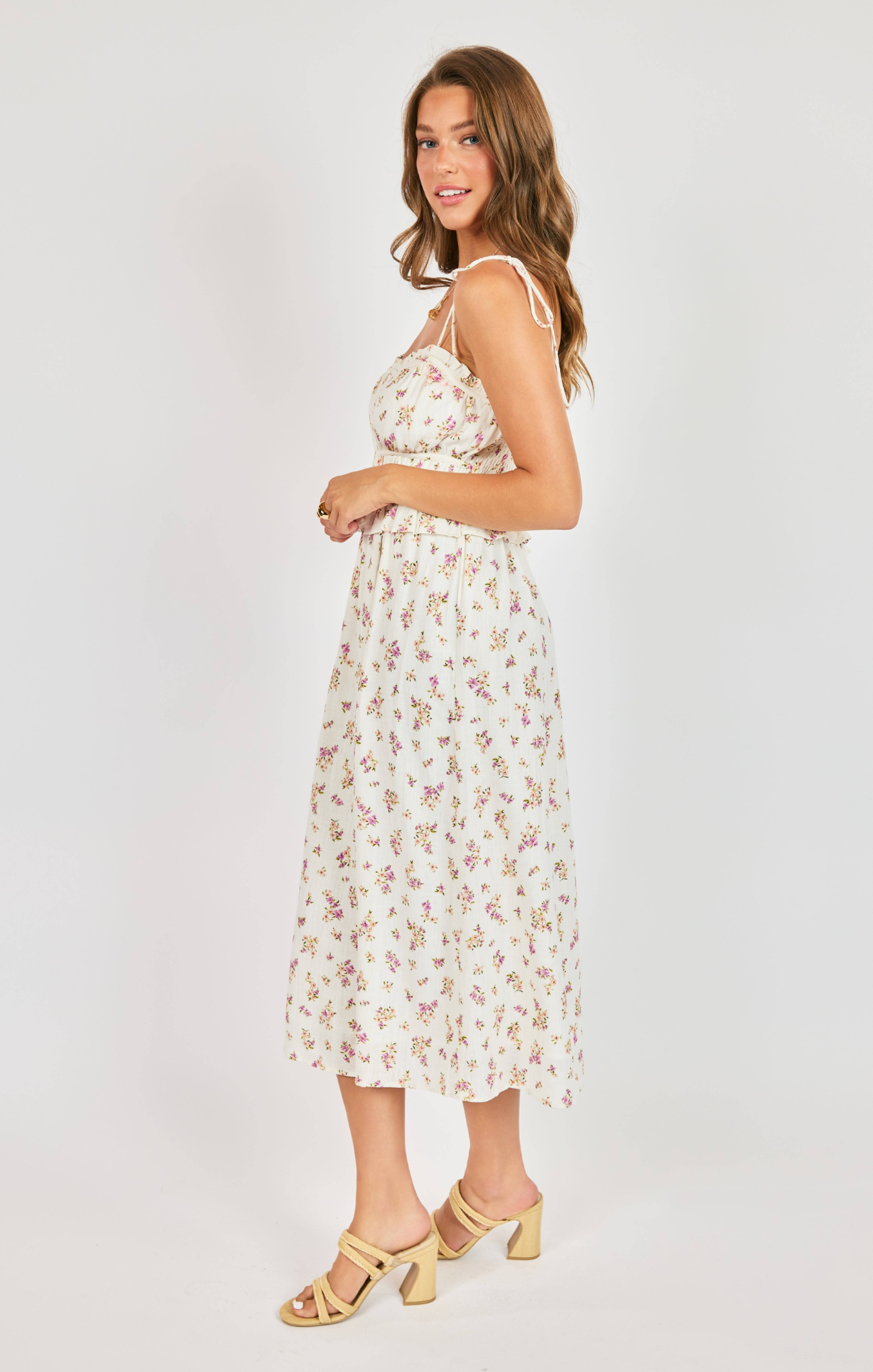 Woman wearing a floral dress on a white background