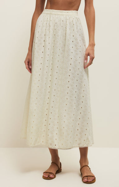 Person wearing a white lace skirt on a plain background