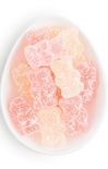Gummy bears in a white bowl on a white background