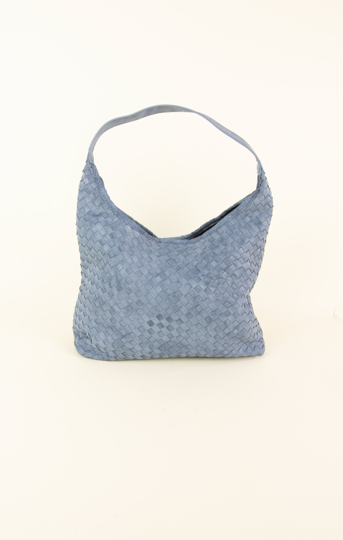 Blue textured handbag on a light beige background