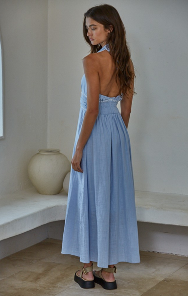 woman wearing blue dress in white house