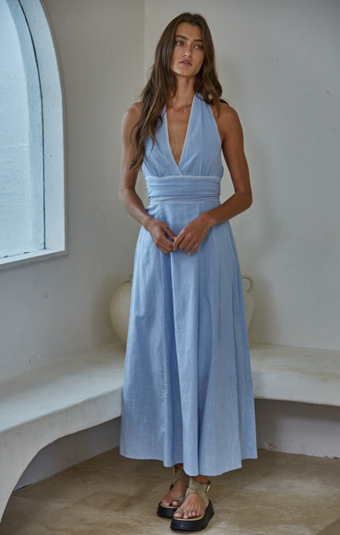 woman wearing blue dress in white house