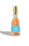 Bottle of champagne gummy bears with a gold cap on a white background