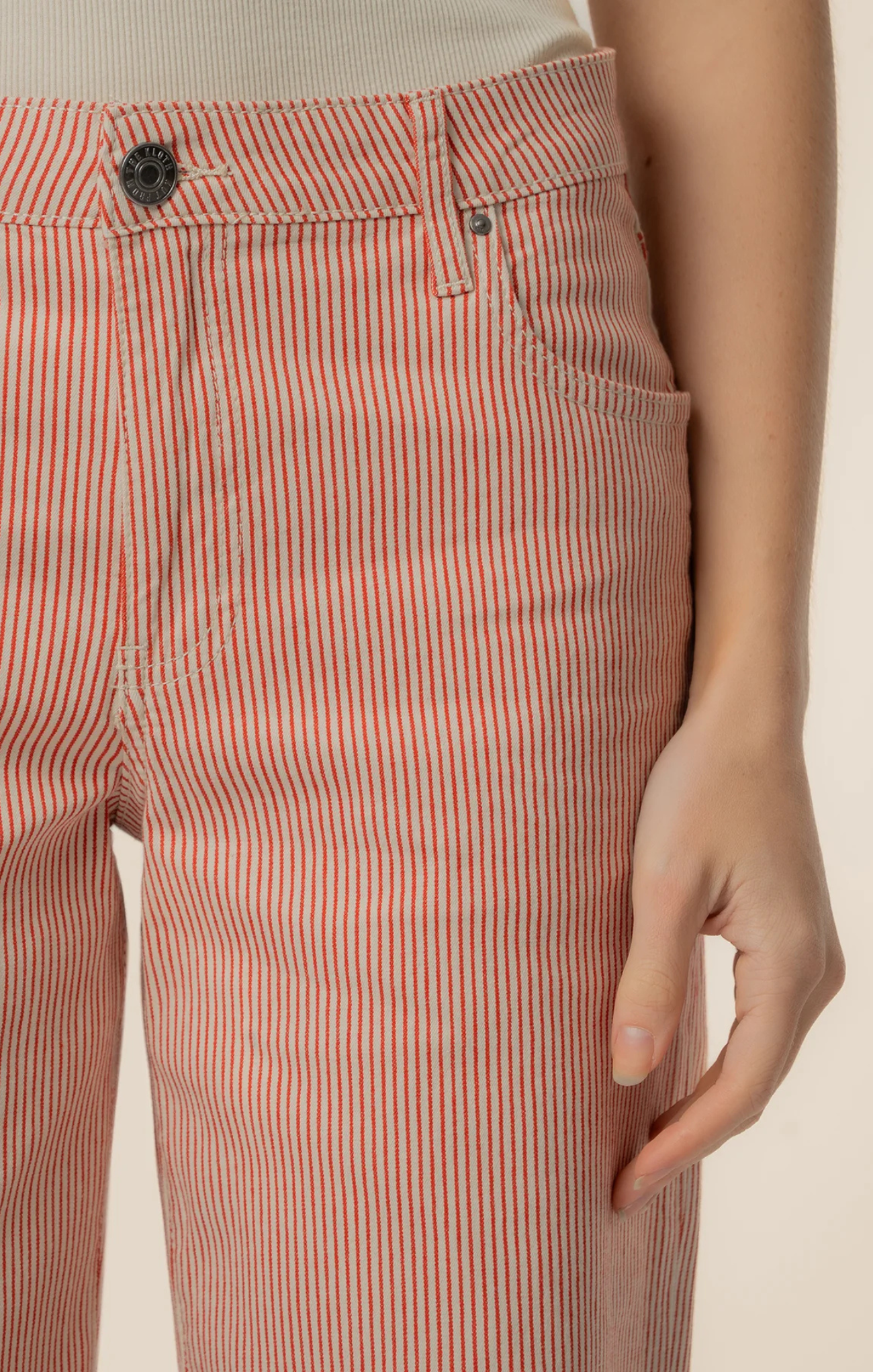 Close-up of red and white striped pants with a neutral background