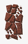 Broken chocolate pieces and cocoa beans on a white background