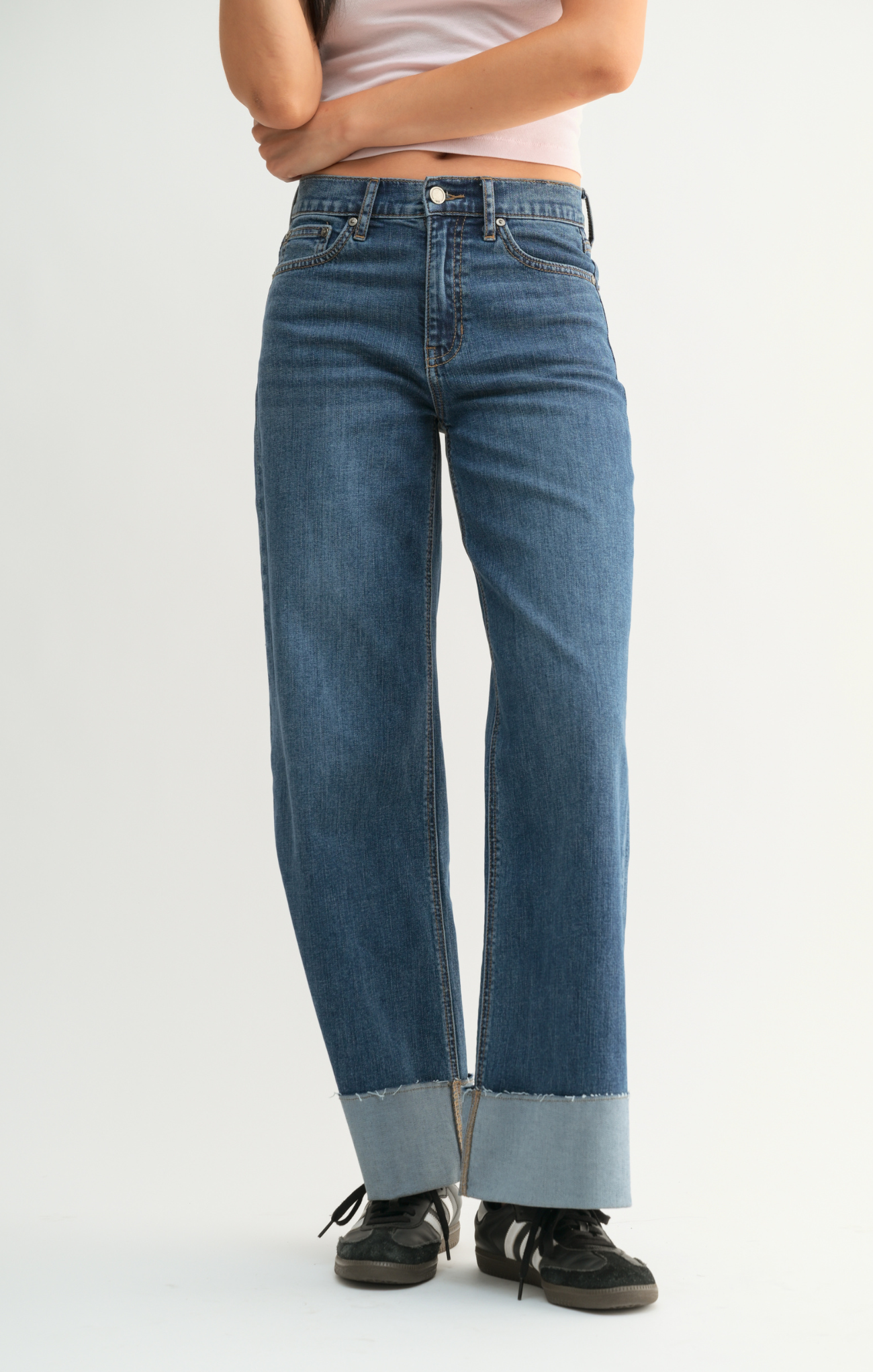 Person wearing blue jeans on a white background