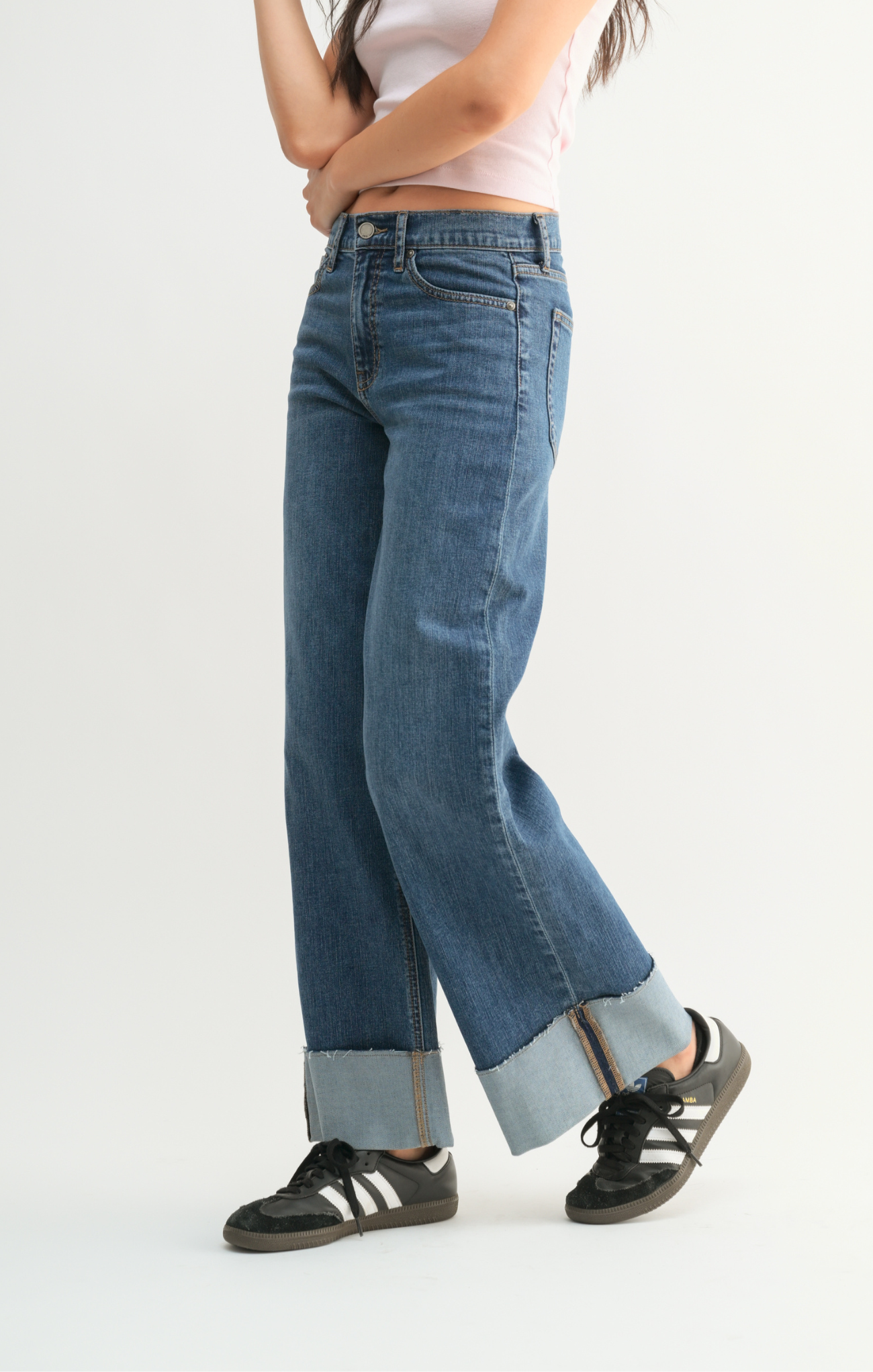 Person wearing blue jeans with a white background