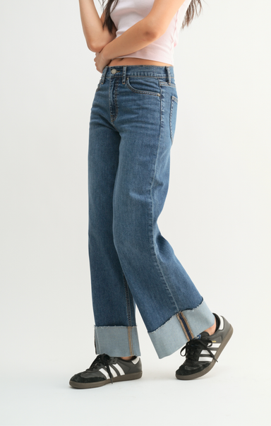 Person wearing blue jeans with a white background