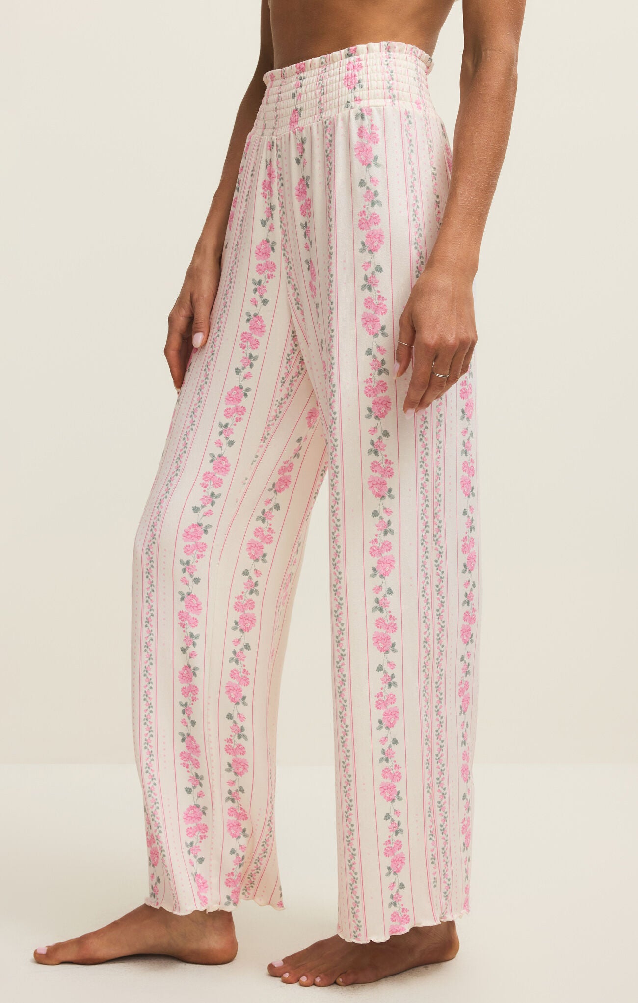 Person wearing floral pants on a white background