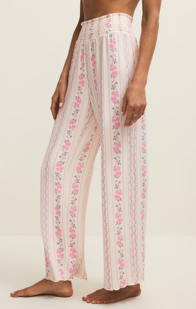 Person wearing floral pants on a white background