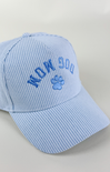 Light blue and white striped baseball cap with “Dog Mom” embroidered in blue lettering above a blue paw print on the front.