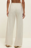 White wide-leg pants worn by a person on a plain background